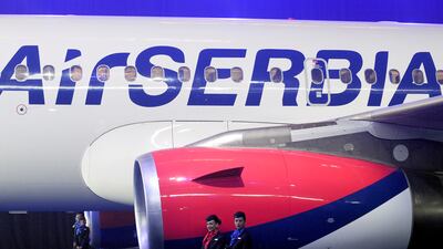 Air Serbia’s flight attendants stand in front of the jet engine during an official ceremony of unveiling the first Air Serbia Airbus A319-100 airplane at Belgrade’s Nikola Tesla Airport. ANDREJ ISAKOVIC / AFP
