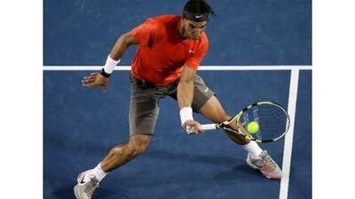 Rafael Nadal concentrates on a forehand against Bernard Tomic yesterday. Clive Brunskill / Getty Images