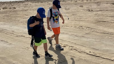 Finlay and his brother Frankie walk in the desert.