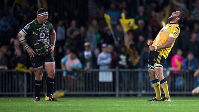 Wellington Hurricanes player Jeremy Thrush, right, celebrates Saturday's victory over Blue Bulls as Bulls player Wener Kruger looks on. Marty Melville / AFP / April 5, 2014