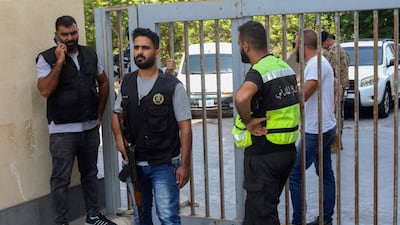 Members of Lebanon's security forces and emergency services arrive at a bank branch held up by an angry depositor demanding access to his savings in the southern city of Sour. AFP