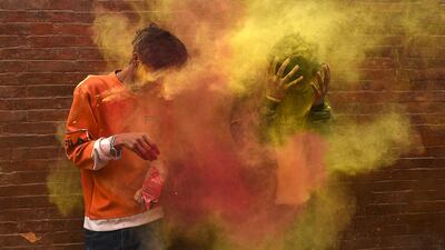 Revellers play with coloured powders as they celebrate Holi, the spring festival of colours, in Kathmandu. AFP