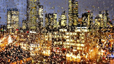 The buildings of the banking district are seen through thousands of rain drops on a glass railing in central Frankfurt, Germany. Michael Probst / AP Photo