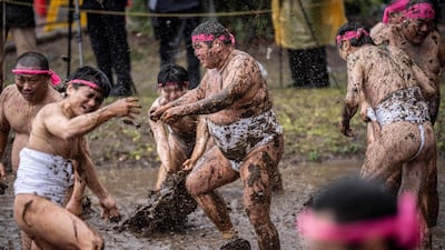 Participants hurl mud at one another during the Warabi Hadaka festival in Yotsukaido, Japan. AFP