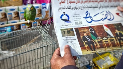 A local newspaper carries a report on the postponement of Libya's presidential elections that had been scheduled for Friday. AFP