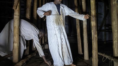 Artisans work on the reconstruction of one of the buildings.