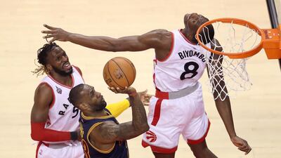 LeBron James of the Cleveland Cavaliers drives to the basket against Bismack Biyombo and DeMarre Carroll of the Toronto Raptors in the first half of game four of the Eastern Conference Finals during the 2016 NBA Playoffs at the Air Canada Centre in Toronto. Tom Szczerbowski / Getty Images / AFP
