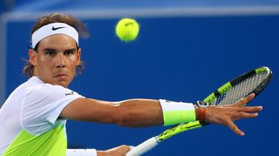 Rafael Nadal returns the ball to David Ferrer. Marwan Naamani / AFP