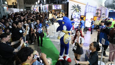 Crowds gather around the Sega and Atlus area at Tokyo Game Show, where major publishers are competing for attention with playable demos, elaborate displays and giveaways. AFP