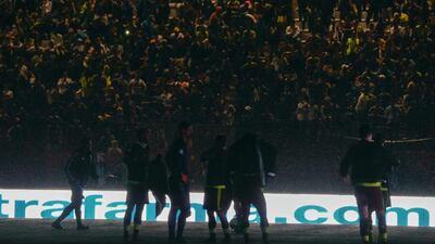 Venezuela players on the pitch and the fans in the stand during the blackout. Juan Barreto / AFP