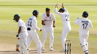 India's Ravichandran Ashwin celebrates with teammates after taking the wicket of South Africa batsman Keegan Petersen for 28. Reuters