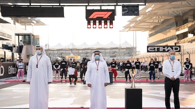 Sheikh Saif bin Zayed Al Nahyan, Deputy Prime Minister and Minister of Interior, Khaldoon Al Mubarak, CEO and Managing Director Mubadala, Chairman of the Abu Dhabi Executive Affairs Authority and Abu Dhabi Executive Council Member (L) and Chase Carey, Formula 1 Chairman and CEO (R), stand for the UAE national anthem at Yas Marina Circuit. Hamad Al Kaabi / Ministry of Presidential Affairs. Hamad Al Kaabi / Ministry of Presidential Affairs ---