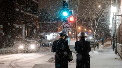 Pedestrians on a snowy street in the Mile End borough of Montreal, in Quebec, eastern Canada. AFP
