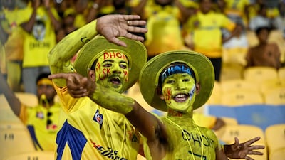 Fans of Chennai Super Kings' MS Dhoni cheer before the start of the match. AFP