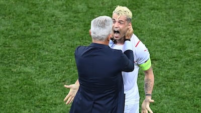 Switzerland's midfielder Granit Xhaka and coach Vladimir Petkovic celebrate after winning their Uefa Euro 2020 round of 16 match against France in Bucharest, Romania, on June 28, 2021. AFP