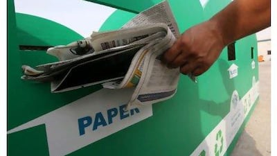 A worker segregates the waste from paper plastics and cans at recycle bins at The Shelter in Al Qouz. Paulo Vecina / The National