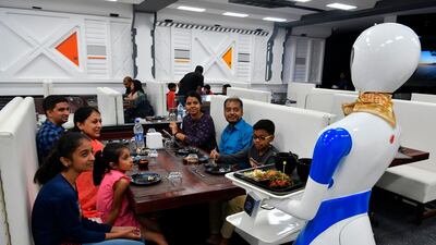 A service robot delivers food to customers. AFP