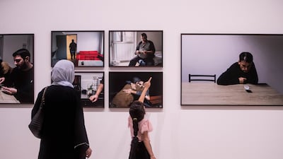 Visitors admiring the exhibition at Vantage Point Sharjah 2023. Leslie Pableo for The National