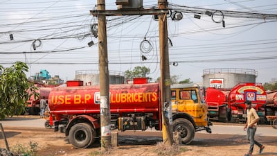 A man walks past tank trucks outside Jamuna Oil Company Fatullah Depot in Narayanganj District, on the outskirts of Dhaka, Bangladesh. EPA