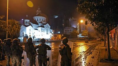 Supporters of Lebanon's Hezbollah and Amal groups clash with security forces late on December 17, 2019 in central Beirut. AFP