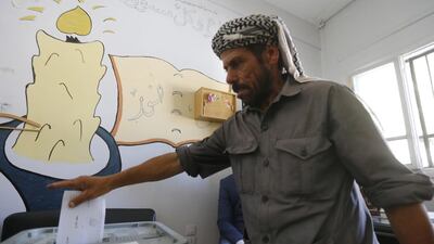 A man casts his ballot for Syria's first local elections since 2011, on September 16, 2018 in the southern Eastern Ghouta, on the eastern outskirts of the capital Damascus. Polling booths opened at 7:00 am (0400 GMT) across government-held parts of the country and will be open for 12 hours, with a potential five-hour extension depending on turnout, reported state news agency SANA. / AFP / LOUAI BESHARA