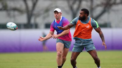 Australia's Bernard Foley, left, releases a pass under pressure from Marika Koroibete. Getty