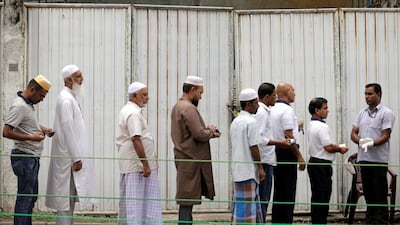 Muslim devotees wait in a line for security check near a mosque in Colombo. Reuters