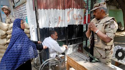 Army officers on guard at a polling station as people enter to vote in Cairo on the second day of a nationwide referendum, on Sunday April 21, 2019. AP