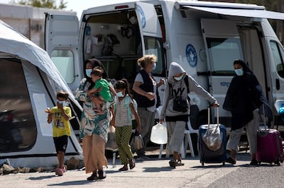 A family from the destroyed Moria camp for refugees and migrants arrives at a new temporary camp, on the island of Lesbos, Greece, September 16, 2020. Reuters