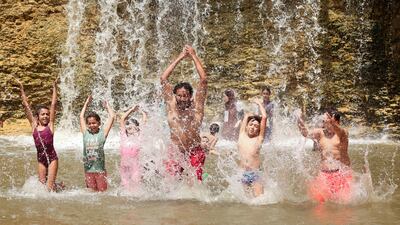 People play at the Wadi El-Rayan waterfalls, amid a heatwave in Al Fayoum Governorate, southwest of Cairo. Reuters