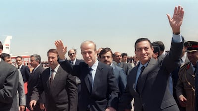 Syrian President Hafez Al Assad and Egyptian President Hosni Mubarak hold hands during a meeting in Damascus. AFP