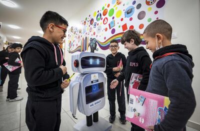 Palestinian students interact with a locally made educational robot during a science class at a private school in Gaza city. AFP