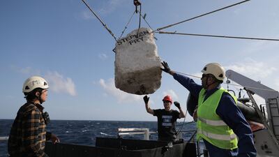 A team on the Greenpeace ship 'Arctic Sunrise' prepare to place a boulder in the sea. Photo: Greenpeace