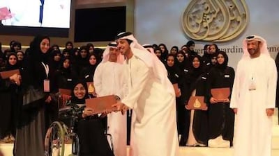 Sheikh Mansour bin Zayed, Deputy Prime Minister and Minister of Presidential Affairs, congratulates Reem Al Dhahani, 19, from Sharjah, who received top exam marks for her arts studies at school. Ravindranath K / The National