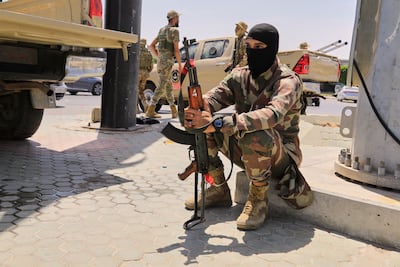A Libyan soldier rests near a checkpoint in Tripoli.