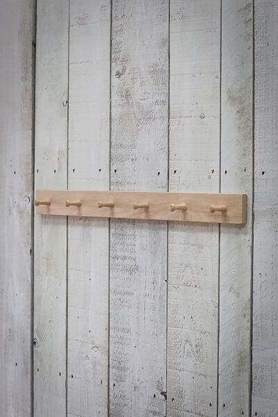 A peg rail is a good place to hang scarves, belts and other accessories. Garden Trading
