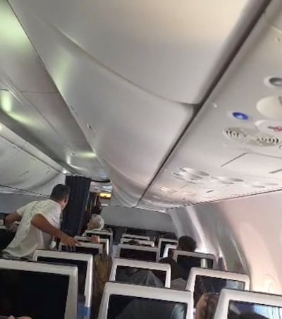 Flydubai passengers react after realising there is commotion in the cockpit. Photo: Reuters