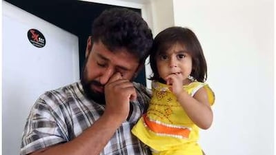 Mukhtiar Ahmed Khudabaksh with his daughter Miriam aged 15 months at his home in Dubai after the final ruling on the murder of his son Moosa.