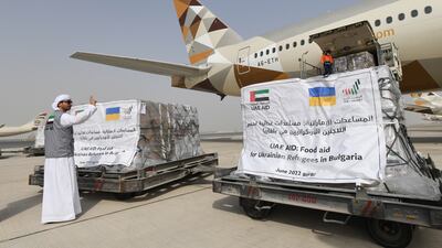 The plane is being loaded with food packets.