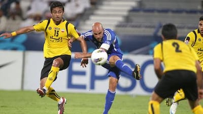 Al Nasr's Mark Bresciano has a shot at goal.