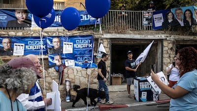 Volunteers set up election campaign posters outside a polling station in Jerusalem on October 27, 2026, on the day of Israel's legislative election. A deeply divided Israel heads to the polls on October 27 for the first time since Hamas's October 7, 2023 attack, with voters delivering their verdict on veteran Prime Minister Benjamin Netanyahu and the country's rightward drift. (Photo by John WESSELS / AFP)