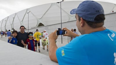 Fans take a photo outside the Arena Amazonia Vivaldo Lima on Sunday. Bruno Kelly / Reuters / March 9, 2014