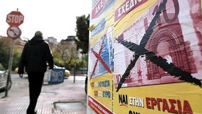 A poster in Athens reads “Yes to work. No to the euro”. Petros Giannakouris / AP Photo