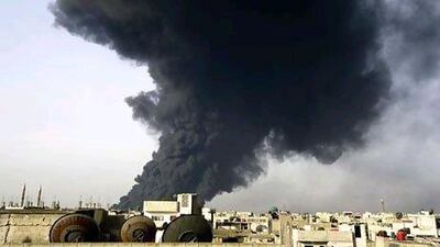 Smoke rises from a refinery in Homs, Syria, a flashpoint between rebels and the government, after being hit by an explosion. AFP / HO / SANA