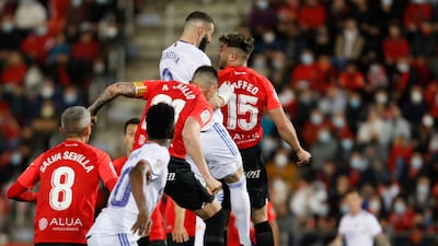 Real Madrid's Karim Benzema, centre, jumps to head home his side's third goal. It was the French striker's 413th career goal, to see him overtake Thierry Henry's previous mark. AP