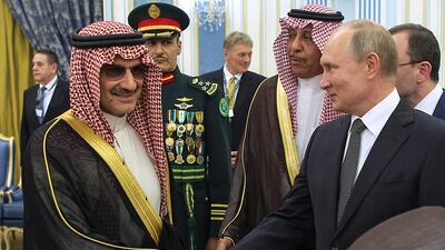 Mr Putin shakes hands with Saudi Prince AlWaleed bin Talal in Riyadh. AFP