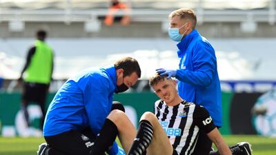 Newcastle United's Ciaran Clark receives medical attention after sustaining an injury. Reuters
