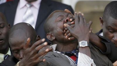 Security personnel drag away a Kenyan journalist, as President Mwai Kibaki's delivers his speech during Independence Day (Jamhuri Day) celebrations at the Nyayo National Stadium in Nairobi last month.