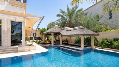 The garden is a peaceful haven with its seating and landscaping.