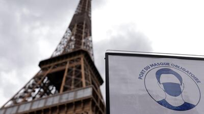 A sign that reads, "Mandatory to wear a mask on all the site", is seen at the entrance of the Eiffel Tower as she gets ready to re-open to the public following the coronavirus outbreak, in Paris, France. Reuters